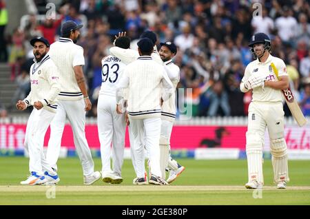 India's Virat Kohli (left) celebrates after Mohammed Siraj catches the ball of England's Rory Burns (right) during day five of the cinch Second Test match at Lord's, London. Picture date: Monday August 16, 2021. Stock Photo