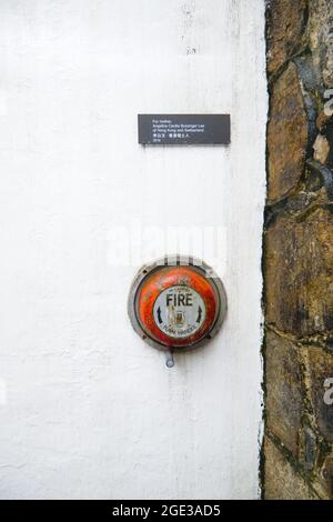 Hong Kong - 12 Aug 2021: Red Alarm on White wall at Asian Centre of Hong Kong, translation: Angelina Lee of Hong Kong and Switzerland Stock Photo
