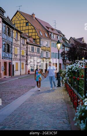 Colmar, Alsace, France. Petite Venice, water canal, and traditional half timbered houses. Colmar is a charming town in Alsace, France. couple man and women walking at the street during vacation Stock Photo