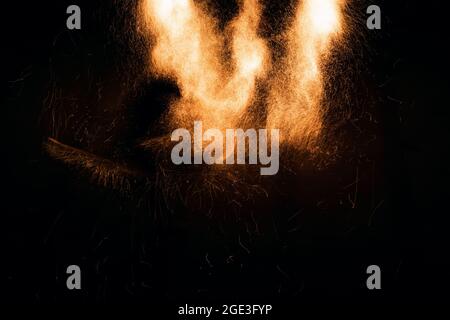 Beautiful abstract background on the theme of fire, light and life. Burning embers glowing flying away particles over black background. Stock Photo