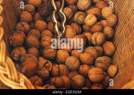 Walnut in a wicker basket. Background of nuts. Stock Photo