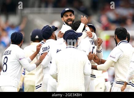 India's Virat Kohli (top) celebrates the wicket of England's Jonny Bairstow after a video review during day five of the cinch Second Test match at Lord's, London. Picture date: Monday August 16, 2021. Stock Photo