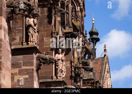 Freiburg, Germany. 16th Aug, 2021. Stone figures and gargoyles can be seen on the southern façade of Freiburg Cathedral. Freiburg Cathedral is formally a cathedral, as Freiburg has been an episcopal see since 1827. The Archdiocese of Freiburg was formally established on 16 August 1821 by Pope Pius VII with the bull 'Provida solersque'. Credit: Philipp von Ditfurth/dpa/Alamy Live News Stock Photo
