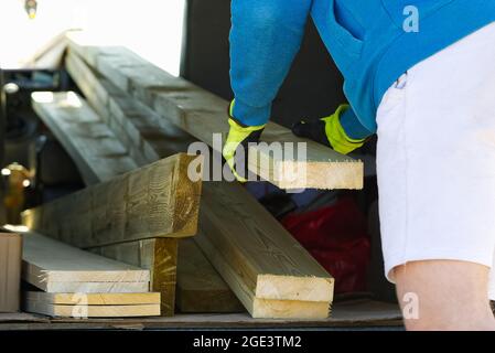 worker loading wood board to car for transportation. close-up Stock Photo