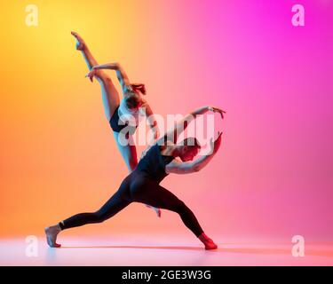 Two dancers, stylish sportive couple, male and female models dancing