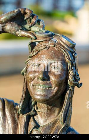 Detail of the statue of the famous 1930's flying legend Amy Johnson created by artist Stephen Melton on Herne Bay seafront. Head with face, smiling. Stock Photo