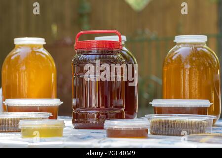 Bee honey is packaged in glass and plastic containers and is ready for sale to customers in market Stock Photo