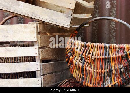 Knitted basket and wooden boxes on the street Stock Photo