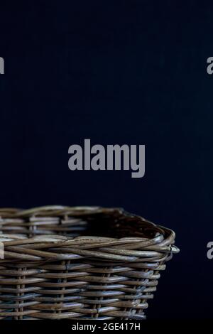 Empty wicker basket on a black background. Stock Photo