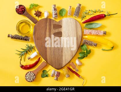 Various herbs and spices on yellow background Stock Photo