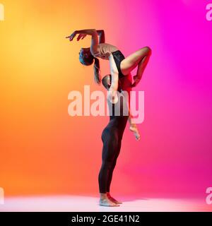 Two dancers, stylish sportive couple, male and female models dancing