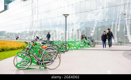 POZNAN, POLAND - Jan 31, 2016: A row of locked bicycles in front of the Galeria Malta shopping mall Stock Photo