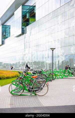 POZNAN, POLAND - Jan 31, 2016: A ow of locked bicycles in front of the Galeria Malta shopping mall Stock Photo