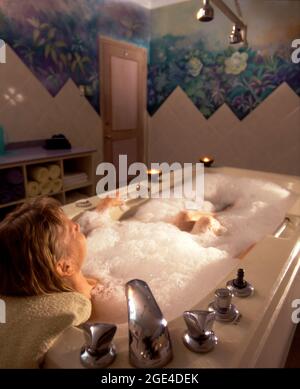Woman relaxing in bathtub with bubble bath soap Stock Photo