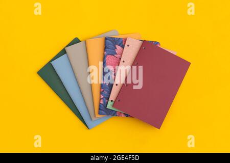 Notebooks on yellow background. Top view. Flat lay. Back to school concept. Stock Photo