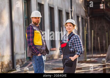 Two young engineers outdoors at the factory Stock Photo