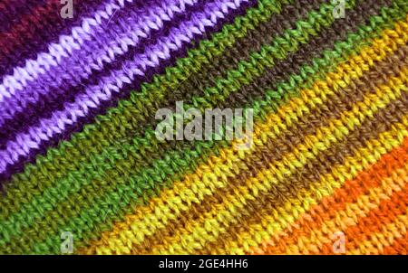 Purple and Yellow Tone Striped Alpaca Knitted Wool Fabric Texture in Diagonal Patterns for Abstract Background Stock Photo