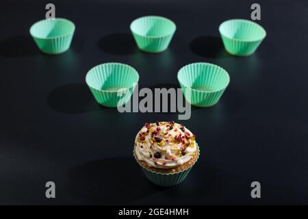 Silicone mint color  molds for cup cake baking on black background. Stock Photo