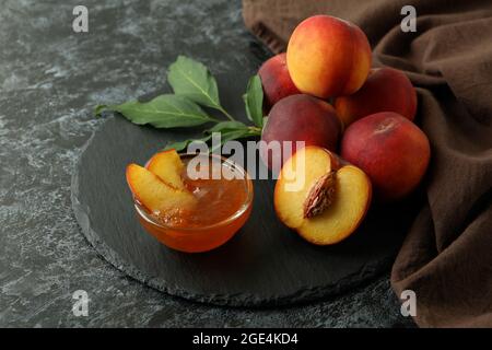 Peach jam and ingredients on black smokey table Stock Photo