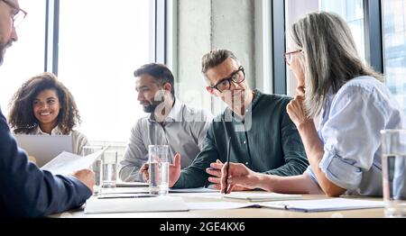Diverse businesspeople executive team negotiating at boardroom meeting. Stock Photo