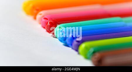 A rainbow colour spectrum of felt tip pens set against a white background. Stock Photo