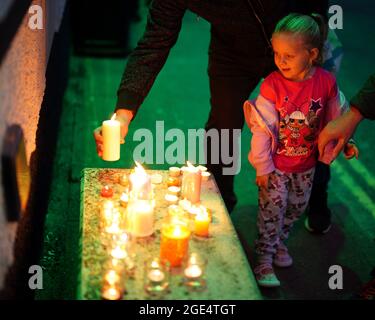 Members of the public light candles as they attend a vigil for the community in Plymouth, Devon, where five people were killed by gunman Jake Davison in a firearms incident on Thursday evening. Picture date: Monday August 16, 2021. Stock Photo