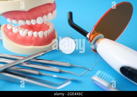 Dental UV lamp for dental jaw filling and instruments on table closeup Stock Photo