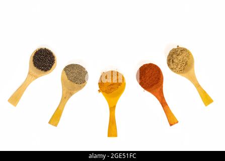 Indian Spicy Masala Powders In Wooden Spoon, White Background. Selective Focus Stock Photo