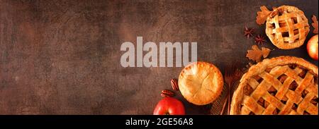 Homemade autumn apple pie corner border banner. Top view over a brown stone background with copy space. Stock Photo