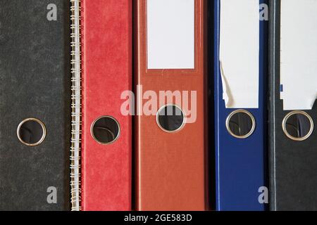 Colored folders for office files and paper on a shelf. Background image Stock Photo
