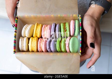 Multicolored sweet macaroons or macaroon flavored cookies in a paper box Stock Photo