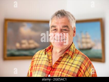 Bochum, Germany. 28th July, 2021. Jürgen Landmann, owner of the Ship in a Bottle Museum, stands in his house in Bochum. Landmann's father opened the museum in 1971. After his death, his son took over the exhibition, which is seen by around 20,000 visitors every year. Landmann is now looking for a successor for his museum in the Hotel Janssen in Neuharlingersiel. (to dpa 'Mini-Welten unter Glas: Buddelschiffmuseum sucht neuer Besitzer') Credit: Caroline Seidel/dpa/Alamy Live News Stock Photo