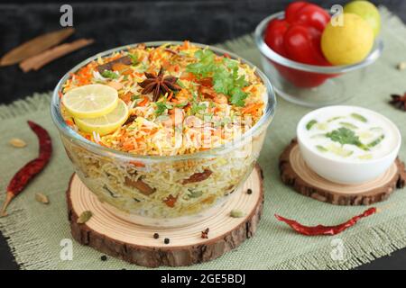 Vegetable biryani biriyani , Hyderabadi Shahi Pulao and raita Pilaf Basmati rice dish Indian spices Kerala India Sri Lanka Pakistan. Ghee rice, Lemon Stock Photo