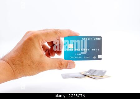 Human hand holding bank credit cards on white background. Stock Photo