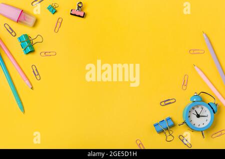 Education, back to school, freelancer work concept. School supplies, stationery accessories on edges over yellow background. Flat lay, top view. Copy space Stock Photo