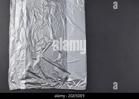 Three plastic bag on dark background, environmental pollution concept. Stock Photo
