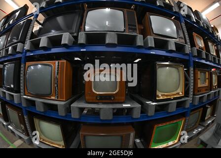 Heusenstamm, Germany. 10th Aug, 2021. Televisions from the 1950s and 1960s stand on pallets in a high shelf in the collection of the Museum of Communication. On 22 August 1931, the first electronic television set was demonstrated at a technology show in Berlin. (to dpa 'The mother of all gawkers: Electronic television has 90th birthday'') Credit: Arne Dedert/dpa/Alamy Live News Stock Photo