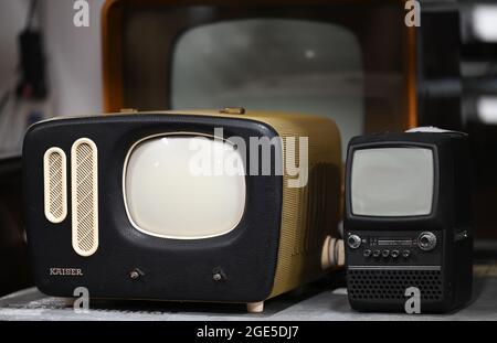 Heusenstamm, Germany. 10th Aug, 2021. An Kaiser Prinz KP60 (1960-62, l) and a portable television Orbiter (c. 1980) are in the Museum of Communication - Collections. On 22 August 1931, the first electronic television set was demonstrated at a technology show in Berlin. (to dpa 'The mother of all gawkers: Electronic television has 90th birthday'') Credit: Arne Dedert/dpa/Alamy Live News Stock Photo