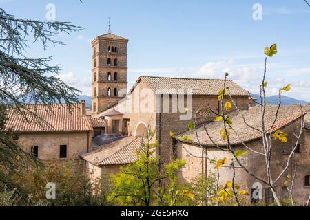 View of Saint Scholastica medieval monastery surrounded, by trees in Subiaco. Founded by Benedict of Nursia Stock Photo