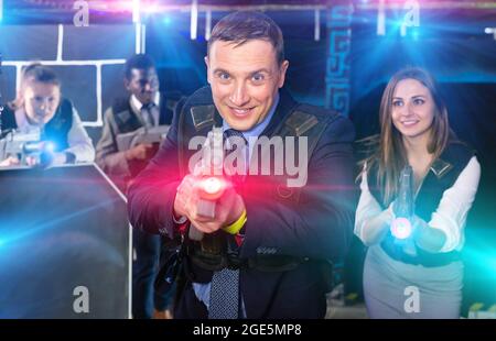 Man holding laser gun and playing laser tag Stock Photo - Alamy