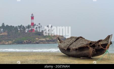Boat canoe aka Vallam on beach side of Vizhinjam lighthouse, Kovalam beach, Kerala, India Stock Photo