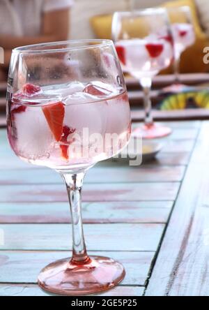 GIN TONIC COCKTAILS WITH FRUIT ON WOODEN TABLE Stock Photo