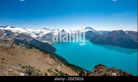 View from Panorama Ridge hiking trail, turquoise glacial Garibaldi Lake, Guard Mountain and Deception Peak, glacier behind, Garibaldi Provincial Stock Photo