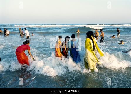 Indian women take bath in the ganges river near old jetty overlooking