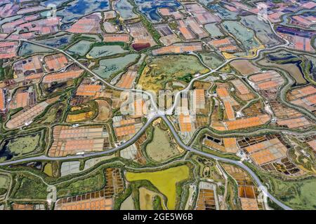 Aerial view of the salt marshes, salt fields of Gurande with country roads and road junction in Brittany at the Atlantic Ocean, Le Marais, Guerande Stock Photo