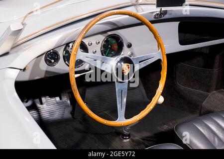 Cockpit, dashboard and wood steering wheel details of a convertible model. At the Porsche Museum in Stuttgart, Germany. Stock Photo