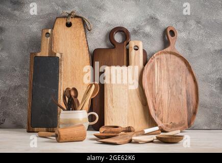 Collection of wooden kitchen utensils, kitchenware, cutting boards and spoons Stock Photo