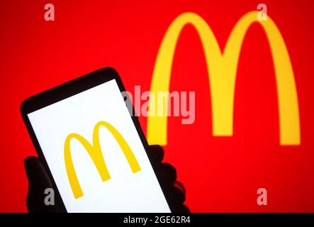 Ukraine. 16th Aug, 2021. In this photo illustration a McDonald's logo is seen on a smartphone in a hand and a pc screen. Credit: SOPA Images Limited/Alamy Live News Stock Photo