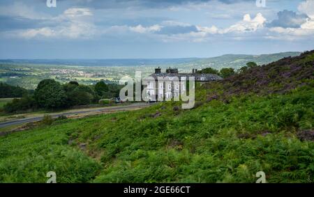 The Cow & Calf Hotel (country inn & restaurant on hill with high picturesque valley view) & moorland bracken - Ilkley Moor, West Yorkshire, England UK Stock Photo