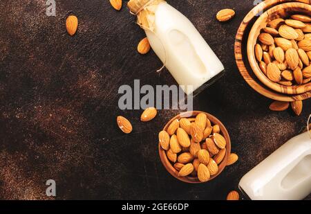 Plant based almod milk in bottles on brown background. Copy space. Top ...